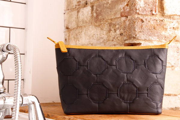 Elvis & Kresse Fire & Hide Cosmetics Case in Blue with yellow fire hose at Supernomad