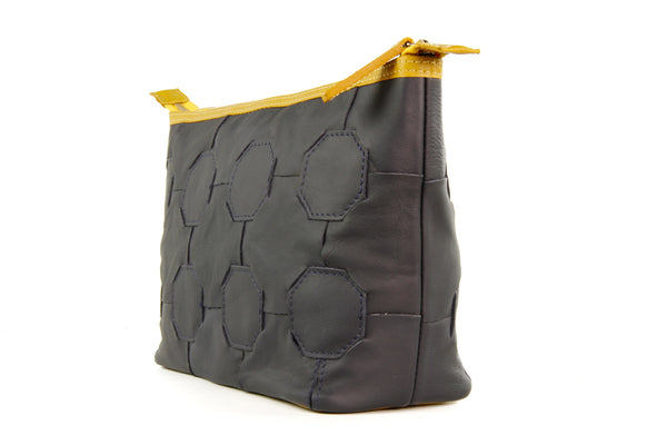 Elvis & Kresse Fire & Hide Cosmetics Case in Blue with yellow fire hose at Supernomad