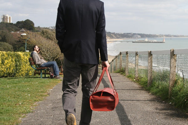 Man carrying vintage Elvis & Kresse Overnight Bag made from ethical material
