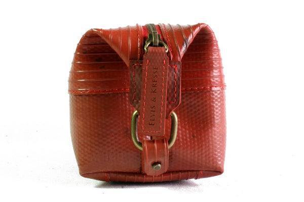 Side view of luxury red Elvis & Kresse Medium Wash Bag